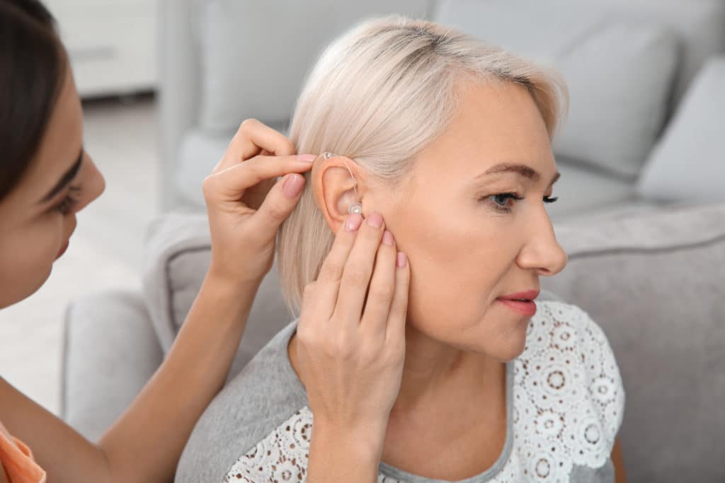 hearing aid being held by audiologist