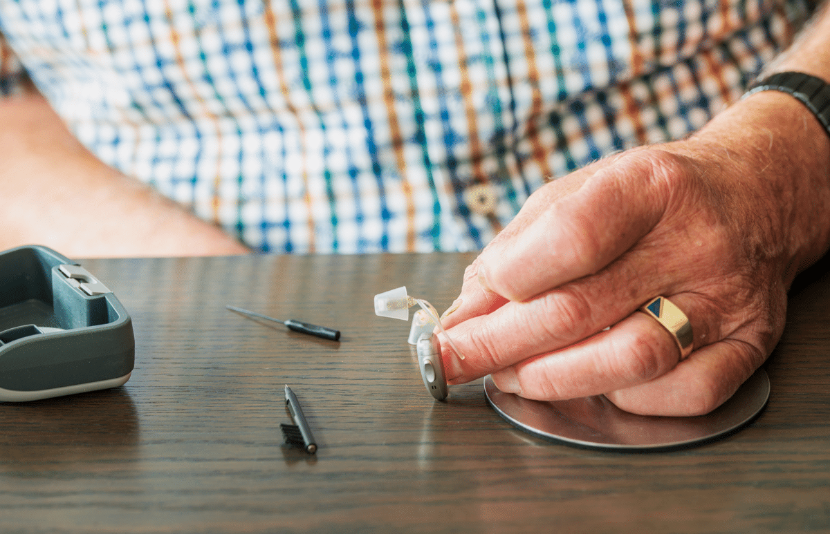 Person cleaning hearing aids