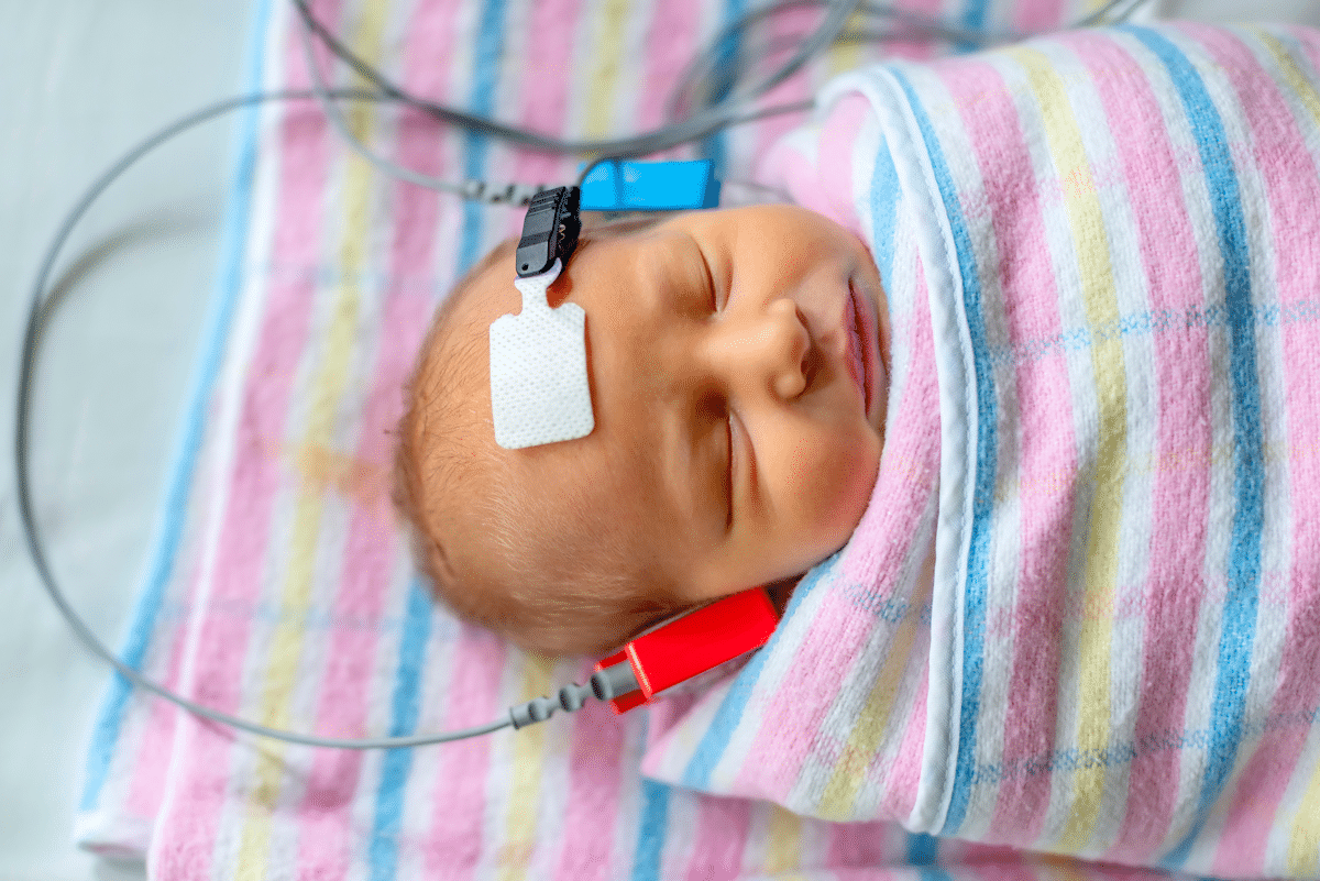 Newborn baby having hearing tested