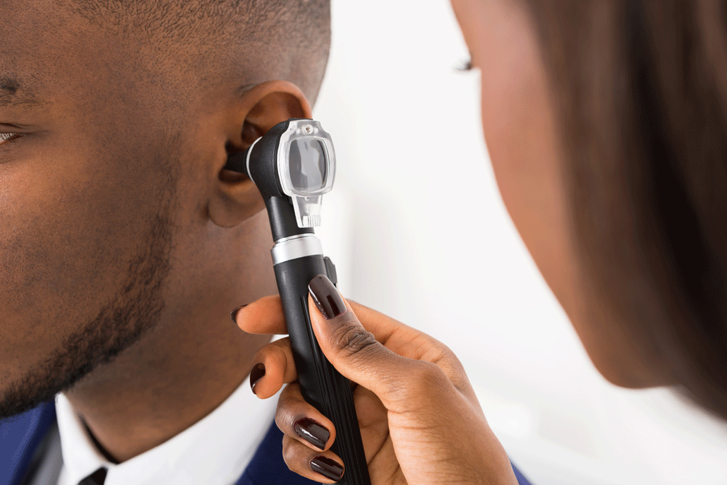 Audiologist Checking Ear