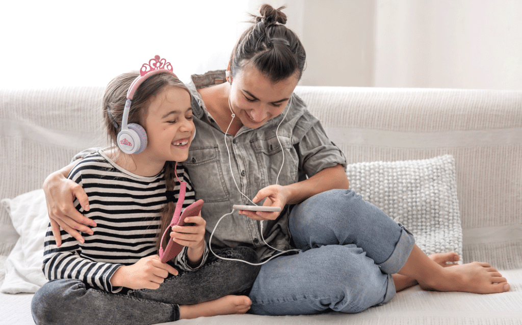 Mother, Daughter listening to music through headphones